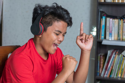 Portrait of smiling young man reading book