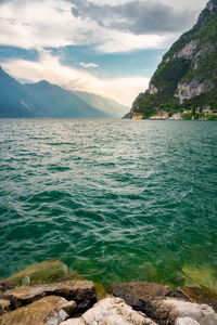 Scenic view of sea and mountains against sky