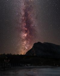 Scenic view of mountains against sky at night