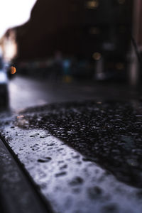Close-up of wet car on street