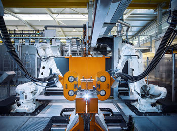 Robotic arms operating inside modern factory