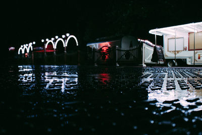 View of bridge over river at night