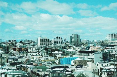 High angle view of city against cloudy sky