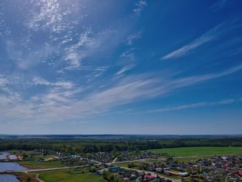 High angle view of field against blue sky