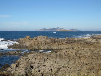 Scenic view of sea against blue sky