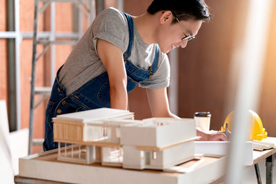 Side view of woman working on table