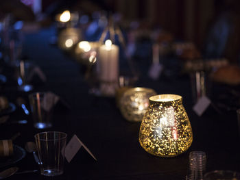 Close-up of illuminated candles on table