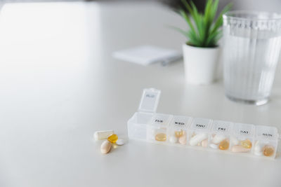 Closeup of medical pill box with doses of tablets for daily take medicine with drugs, capsules