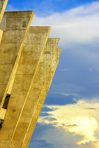 Low angle view of building against cloudy sky