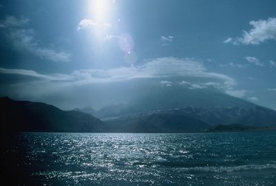 Scenic view of sea and mountains against sky