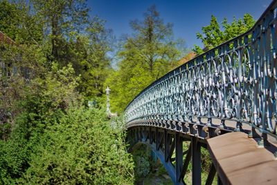 Low angle view of bridge in forest against sky