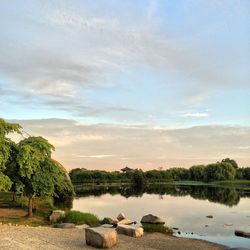Scenic view of lake against cloudy sky