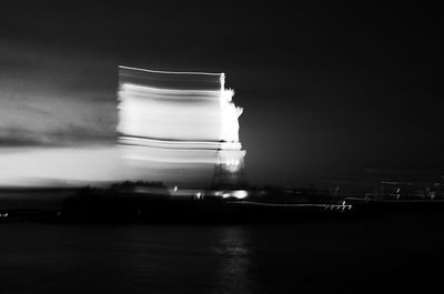 Blurred motion of illuminated statue at night