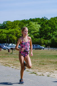 Teenage girl running in swimwear during triathlon