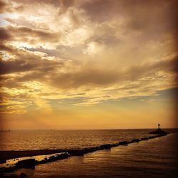 Scenic view of sea against cloudy sky