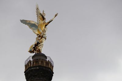 Low angle view of statue against sky