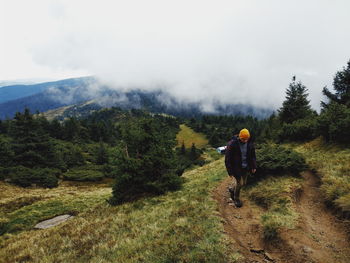 Full length of man amidst trees against sky