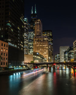 Illuminated city street and buildings at night