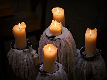 Close-up of lit candles on table