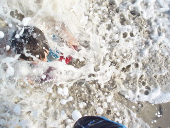 Low section of person standing on snow