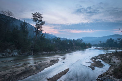 Scenic view of river against sky during winter