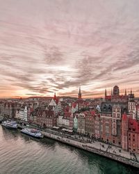 Bridge over river against buildings in city