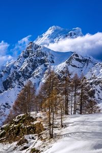 Scenic view of snow covered mountains against sky