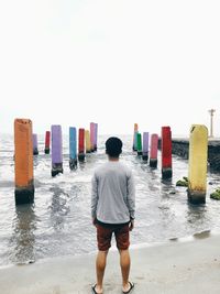 Rear view of woman standing on beach