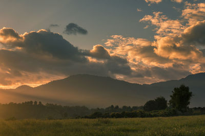 Scenic view of dramatic sky over landscape during sunset