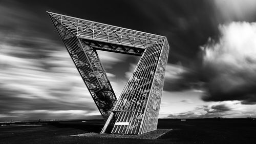 Low angle view of metallic structure against sky in city