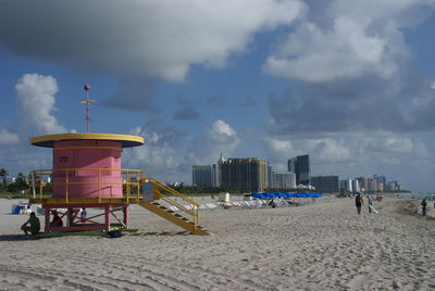 Lifeguard hut on beach against sky