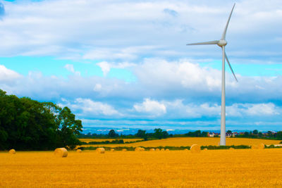 Rural landscape against cloudy sky