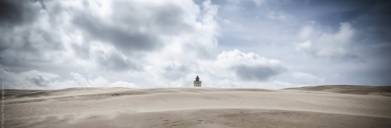 PANORAMIC VIEW OF SAND DUNE ON BEACH AGAINST SKY