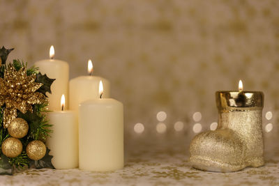 Close-up of illuminated candles on table