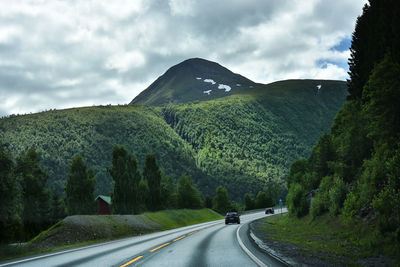 Road amidst trees against sky