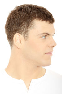 Close-up portrait of young man against white background