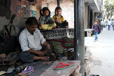 Cobbler repairing slipper at workshop