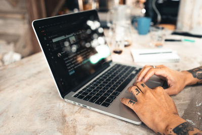 High angle view of man using laptop on table