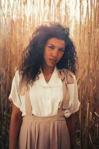 Portrait of woman standing on field