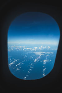 Aerial view of clouds seen through airplane window