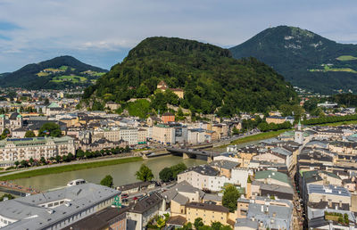 High angle view of townscape and mountains against sky