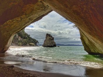 Scenic view of sea seen through cave