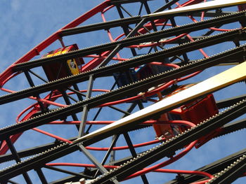 Low angle view of modern structure against blue sky