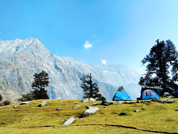 Scenic view of snowcapped mountains against blue sky
