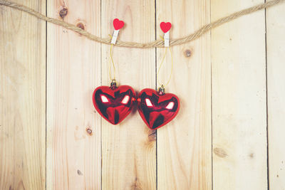 Close-up of heart shape hanging on wood