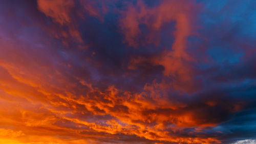 Low angle view of orange cloudy sky