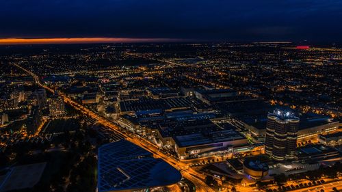 High angle view of illuminated cityscape against sky at night