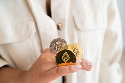 Unrecognizable black girl holding cryptocurrency with hands