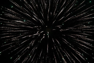 Low angle view of firework display against sky at night