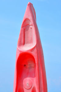 Close-up of red paddleboard against sky